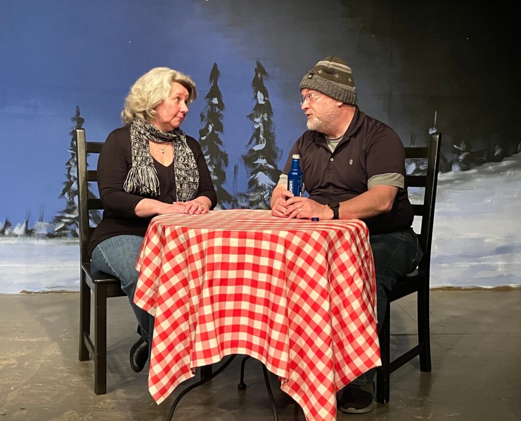 Two actors sitting at a table in "Almost, Maine"